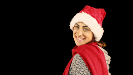 Girl-in-santa-hat-and-warm-clothing-blowing-over-hands