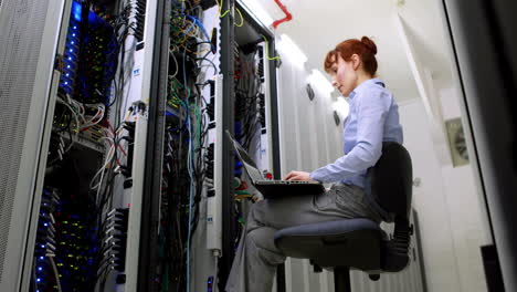 Technician-working-beside-open-server