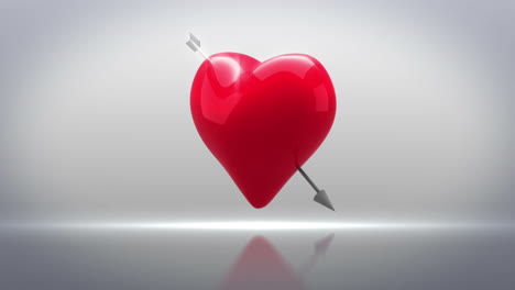 Red-heart-with-an-arrow-turning-on-grey-background