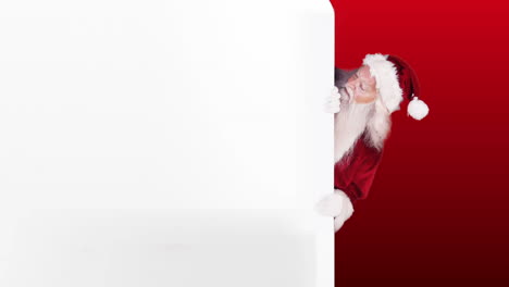 Santa-peeking-around-gift-card-on-festive-background