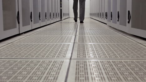 Data-technician-walking-through-locker-hall