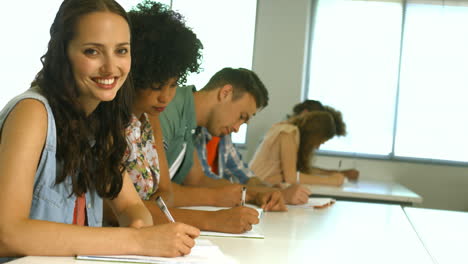 Students-taking-notes-in-lecture