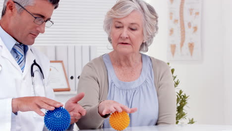 Doctor-showing-patient-how-to-exercise-injured-hand