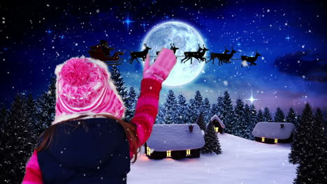 Little-girl-waving-to-santa-flying-over-village