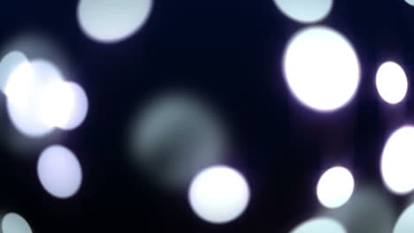 Glowing-circles-of-light-moving-on-black