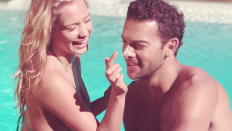 Attractive-couple-relaxing-by-the-pool