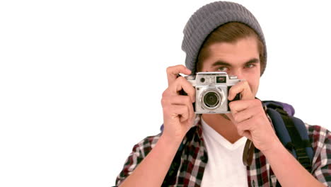 Smilinh-hipster-using-his-retro-camera