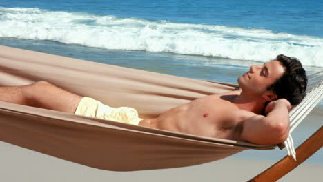 Handsome-man-relaxing-in-a-hammock