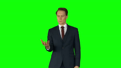 Businessman-lifting-something-on-his-hand-on-green-screen-