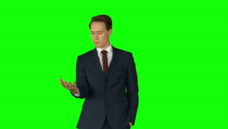 Businessman-lifting-something-on-his-hand-on-green-screen-