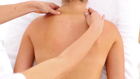 Attractive-woman-receiving-back-massage-at-spa-center