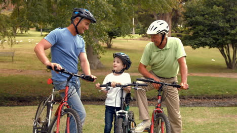 Feliz-Familia-Multigeneracional-En-Bicicleta-En-El-Parque-