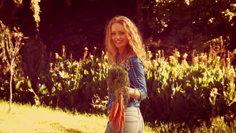 Happy-pretty-woman-holding-carrot