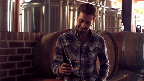 Brewery-worker-toasting-with-a-beer-bottle