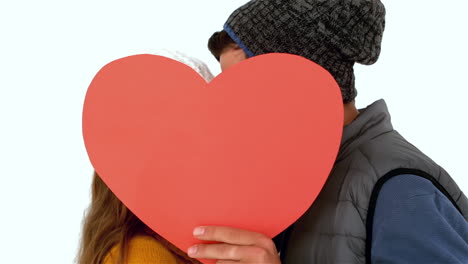 Couple-hiding-faces-with-heart-shape