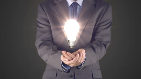 Businessman-presenting-light-bulb-with-hands