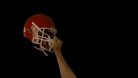 Rugby-player-holds-his-helmet-up-in-air