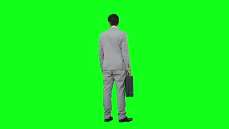 Businessman-standing-holding-his-briefcase