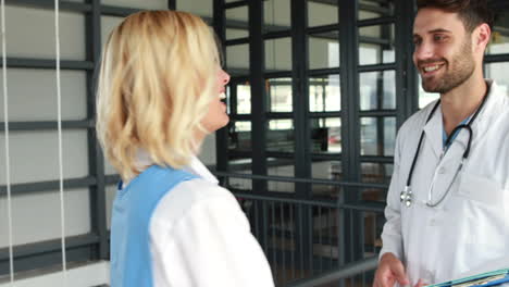 Smiling-doctors-looking-at-documents