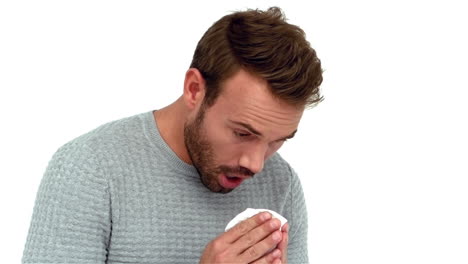 A-Sick-man-sneezing-into-a-tissue