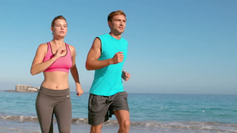 Couple-jogging-on-beach