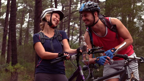 Couple-biking-through-a-forest