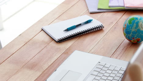 Upward-view-of-a-laptop-and-notebook-on-a-desk