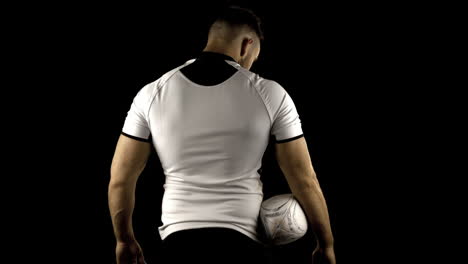 Serious-rugby-player-holds-rugby-ball