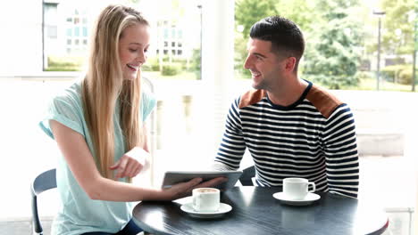 College-students-using-tablet-at-campus-cafe