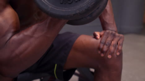 Concentrated-fit-man-holding-dumbbell-