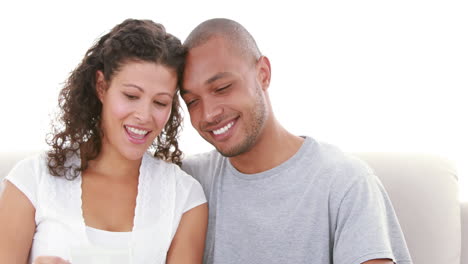 Relaxed-couple-on-the-sofa-looking-at-the-ultrasound