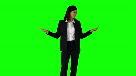 Businesswoman-wearing-something-with-her-hands-on-green-screen-