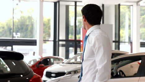 Businessman-looking-at-the-selection-of-cars