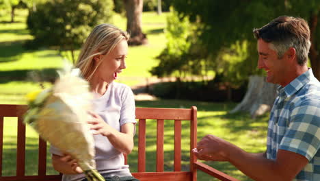 Man-surprising-his-girlfriend-with-a-proposal-in-the-park