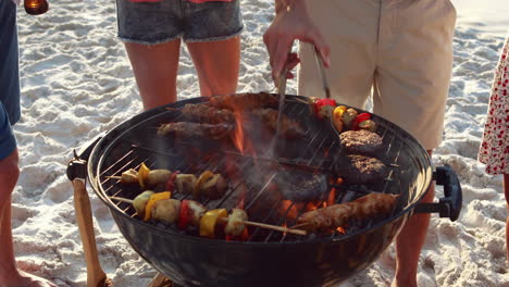 Close-up-of-friends-having-barbecue-together