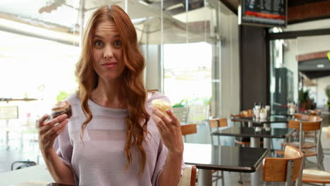 Smiling-woman-enjoying-looking-at-cakes