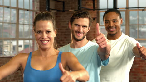 Fit-people-posing-together-in-crossfit-gym