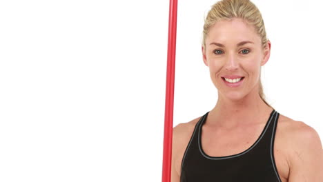 Smiling-fit-woman-holding-javelin