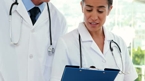 Happy-doctors-looking-at-clipboard