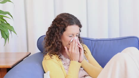 Sick-woman-sitting-on-the-couch