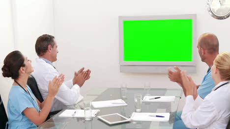 Medical-team-looking-at-green-screen-and-applauding-