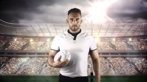 Serious-rugby-player-holding-ball-