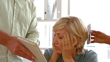 Businesswoman-getting-stressed-with-phone-and-tablet