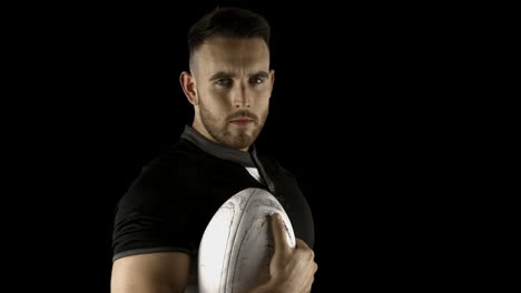 Serious-rugby-player-holding-ball