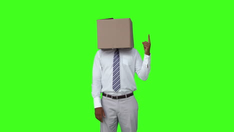 Businessman-with-box-over-head-and-pointing