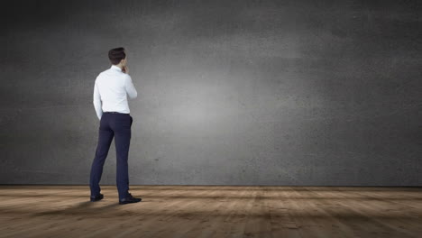 Businessman-looking-at-grey-wall