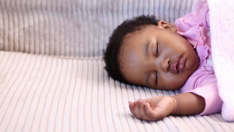 Baby-girl-sleeping-on-the-sofa