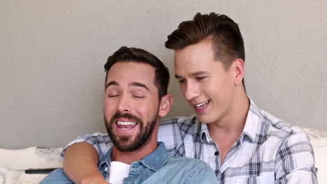 Gay-couple-relaxing-on-the-couch