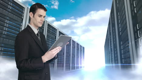 Businessman-using-tablet-computer-in-front-of-server-tower-on-sky-background