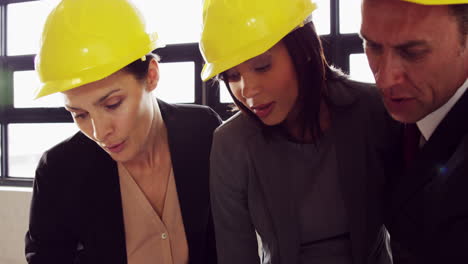 Serious-business-people-working-together-while-wearing-helmet